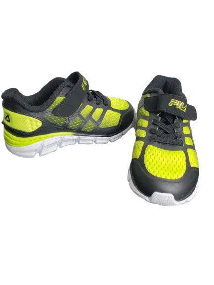 Pair of black and yellow running shoes on a white background