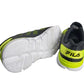 Fila shoes with white soles and green accents on a white background