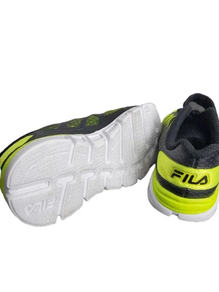 Fila shoes with white soles and green accents on a white background