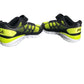 Pair of black and neon green running shoes on a white background
