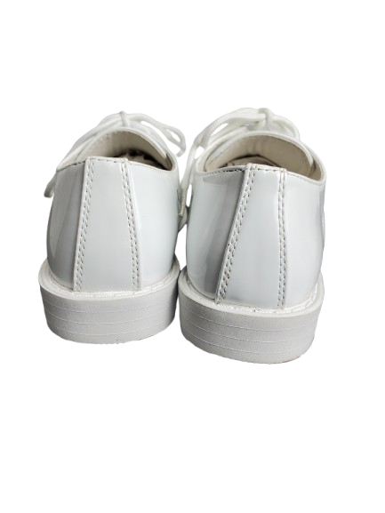 Pair of white patent leather
 on a white background