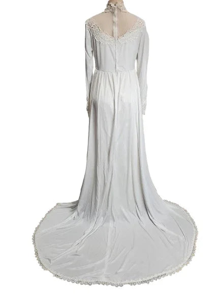 White dress with lace details on a mannequin against a white background