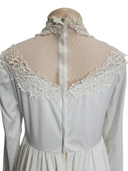 White lace-trimmed blouse on a mannequin with a white background