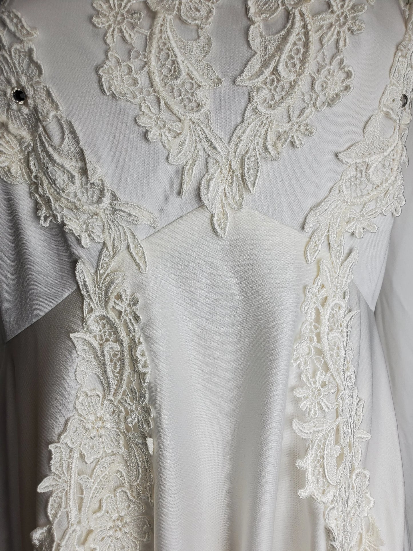 Close-up of white lace fabric on a plain background