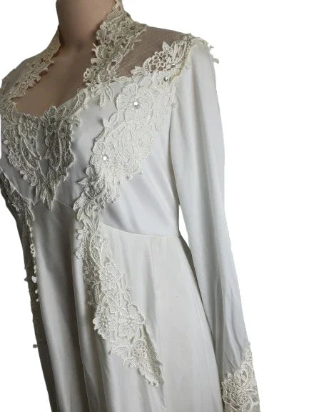 White lace-trimmed garment on a mannequin with a plain background