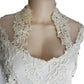 White lace top on a mannequin with a plain background