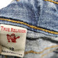 True Religion label on a denim fabric background
