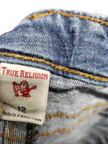 True Religion label on a denim fabric background