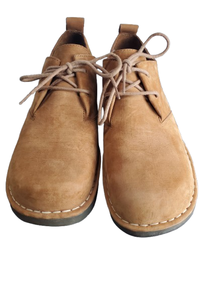 Pair of tan leather shoes with laces on a white background