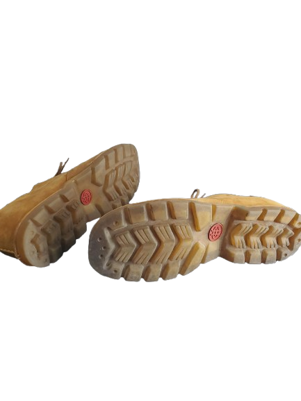 Close-up of beige boots with tread pattern on a white background