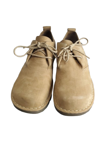 Pair of tan leather shoes with laces on a white background