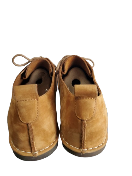Pair of brown children's shoes on a white background