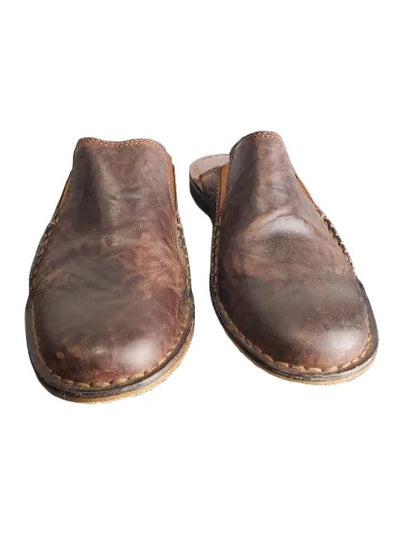 Pair of brown leather shoes on a white background