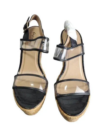 Pair of high-heeled sandals with clear straps on a white background