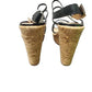 Pair of cork wedge sandals on a white background