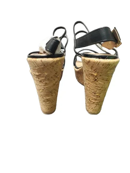 Pair of cork wedge sandals on a white background