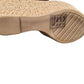 Close-up of a cork shoe sole with brand logo on a white background