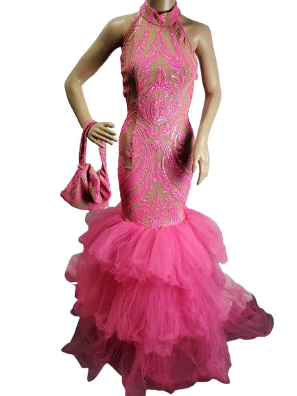 Pink lace evening gown with a matching handbag on a mannequin against a white background