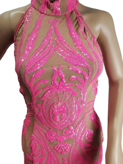 Pink sequin dress on a mannequin against a white background