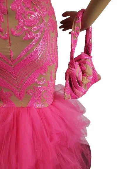 Close-up of a pink sequin dress with matching handbag on a white background