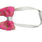 Pink sequined bow tie with a white headband on a white background