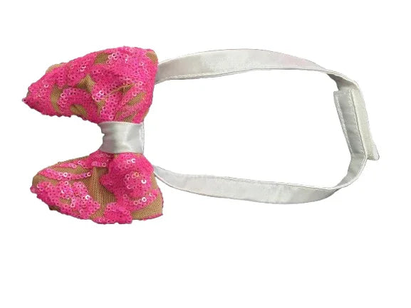 Pink sequined bow tie with a white headband on a white background
