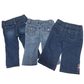 Three pairs of blue jeans on a white background