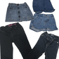 Folded blue jeans and black pants on a white background