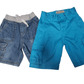 Two pairs of pants, one blue and one denim, on a white background