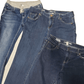Pair of blue jeans with white stripes on a white background