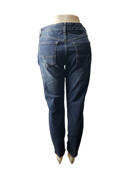 Blue jeans on a mannequin against a white background