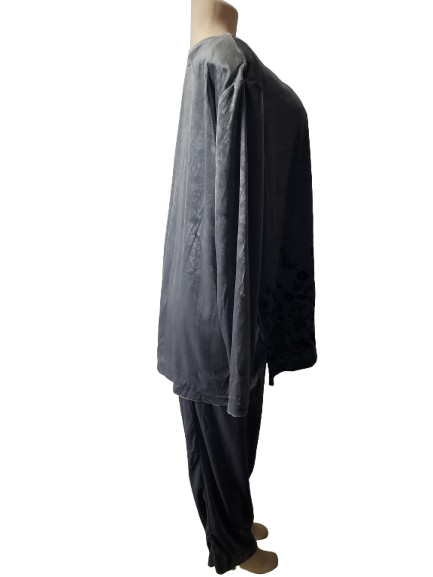 Mannequin wearing a gray top and black pants on a white background