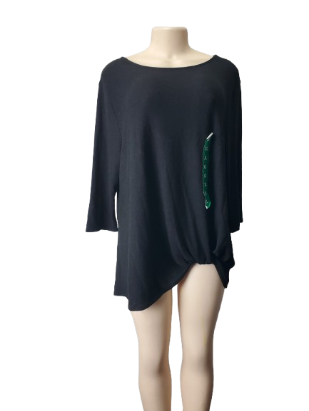 Black top with green embellishment on a mannequin against a white background