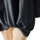 Black oversized sweater with a size label on a white background