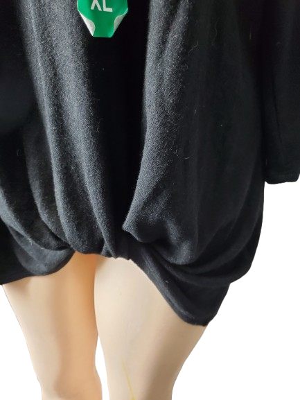 Black oversized sweater with a size label on a white background