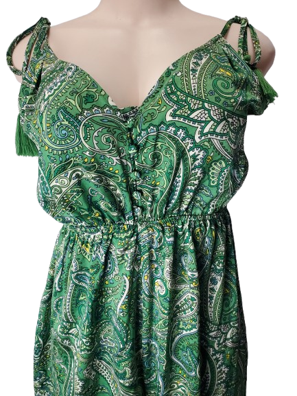 Green paisley patterned dress on a mannequin with a white background
