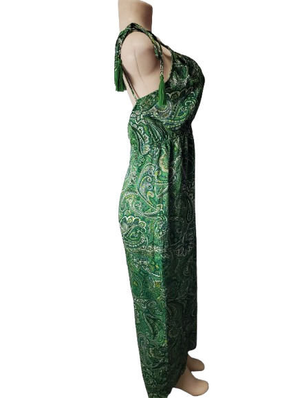 Green patterned dress on a mannequin against a white background