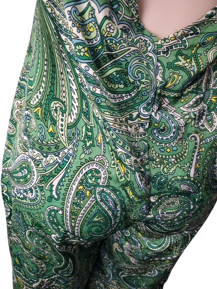 Green paisley patterned fabric on a white background
