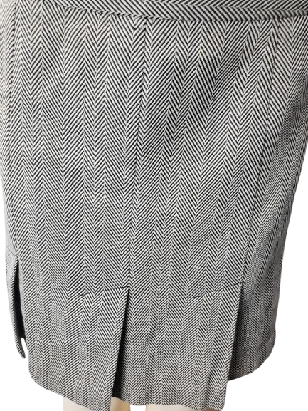 Close-up of a gray and white herringbone patterned skirt.