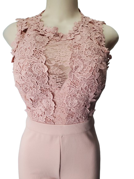 Pink lace top on a mannequin against a white background