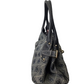 Black patterned handbag on a white background