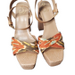 Pair of sandals with colorful strap design on a white background