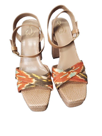 Pair of sandals with colorful strap design on a white background