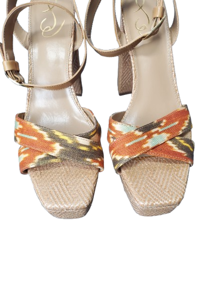 Pair of sandals with woven soles and colorful straps on a white background