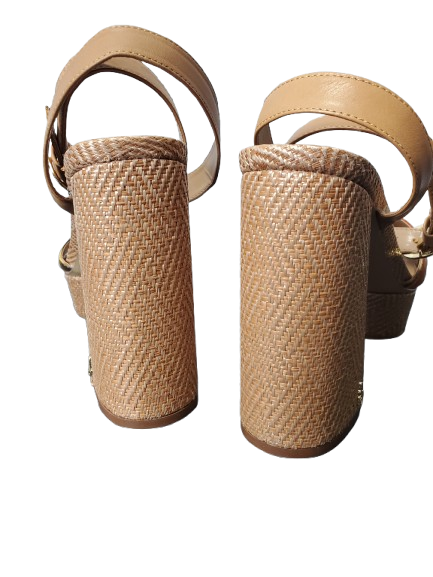 Pair of beige sandals with woven cylindrical platforms on a white background