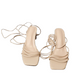 Pair of beige high-heeled shoes with ruched straps on a white background