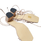 Pair of beige shoe inserts with black ends on a white background