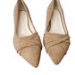 Pair of tan pointed-toe shoes with knotted design on a white background