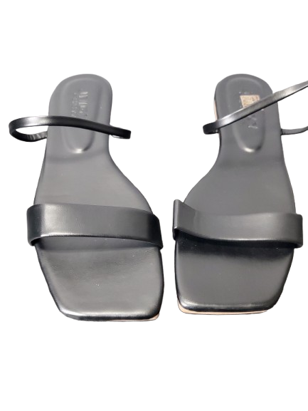 Pair of black sandals with thin straps on a white background