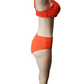 Mannequin wearing an orange bikini set on a white background